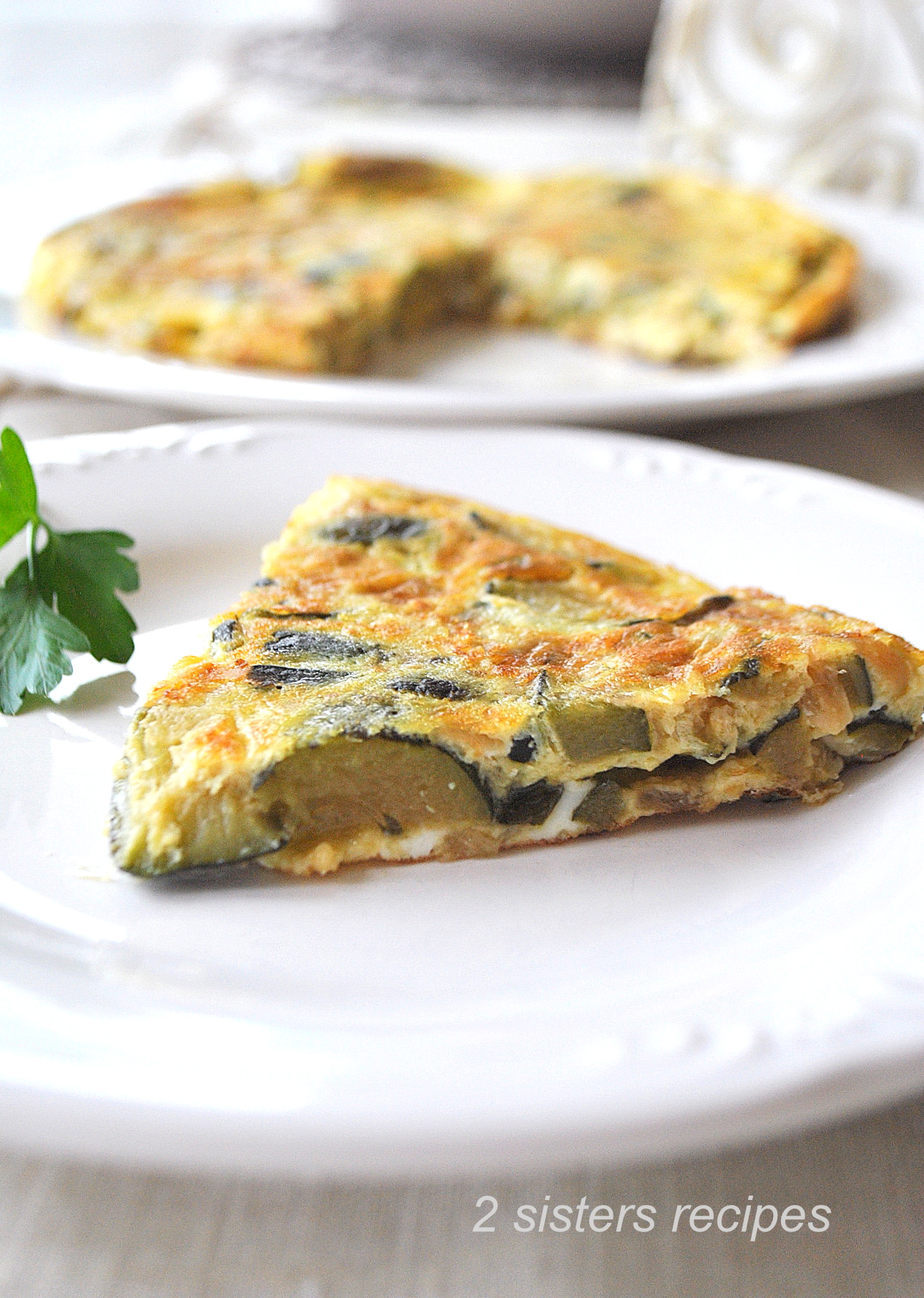 A slice of an Italian omelet served on a white plate.