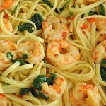 Linguine pasta mixed with cooked shrimp and spinach.