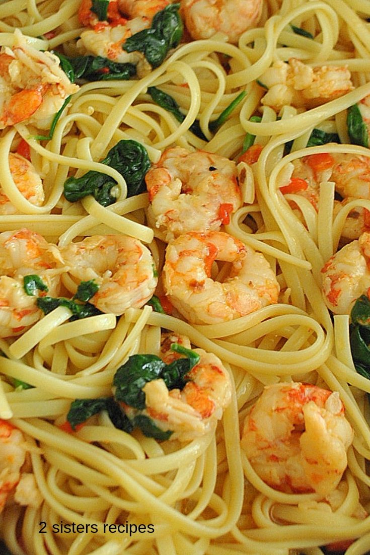 Linguine pasta mixed with cooked shrimp and spinach.