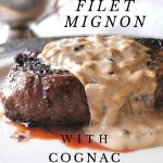 A grilled steak served on a white plate served with a peppercorn sauce on top.