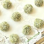 A white plate filled with baked spinach and kale bites.