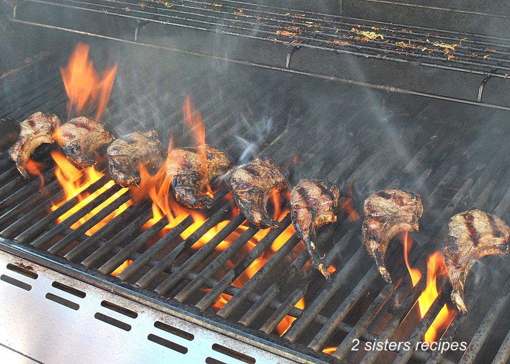 Grilling lamb chops on an outside barbecue.  by 2sistersrecipes.com