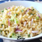 A white bowl filled with pasta salad.