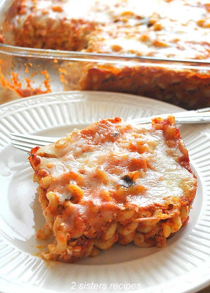 A serving of baked spaghetti on a white dinner plate.