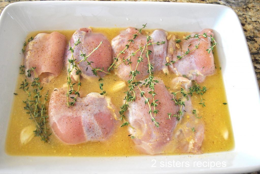 Photo of the thighs marinating in a baking dish by 2sistersrecipes.com 