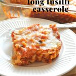 A white plate with a serving of our baked spaghetti, only its fusilli pasta.