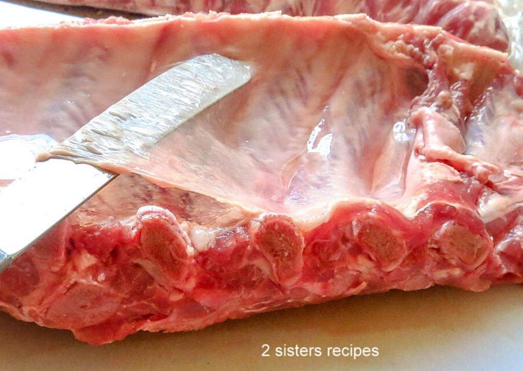 Removing the silver lining from the back of the ribs by 2sistersrecipes.com