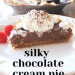 A slice of chocolate cream pie topped with some whipped cream served on a white plate.