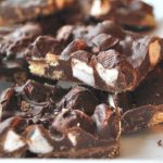 A plate with a pile of cut up chocolate bark.