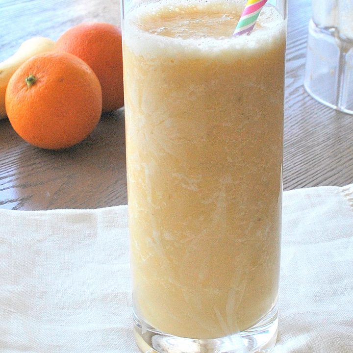 Orange Smoothie served in a tall glass with a straw.