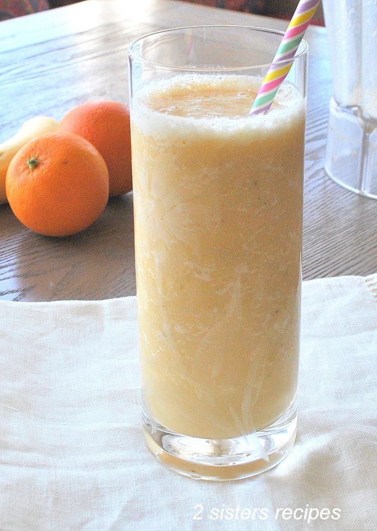 Healthier Orange Creamsicle Smoothie served in a tall glass with a straw.