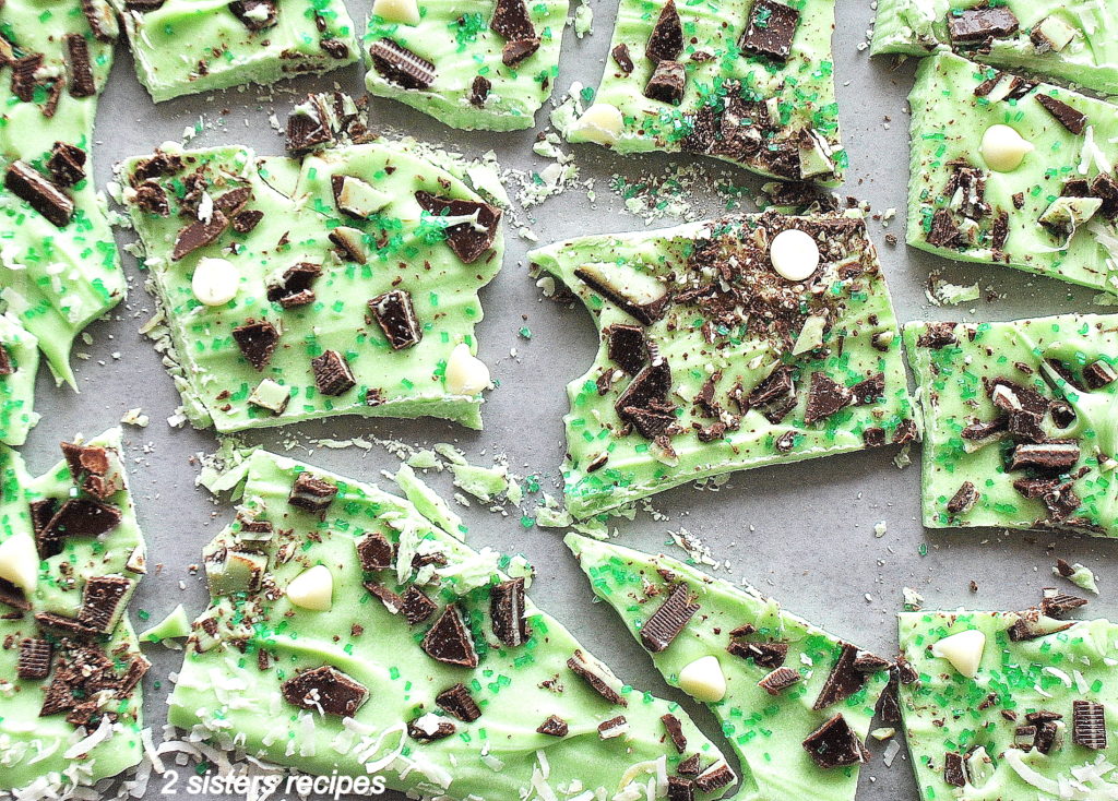 Pieces of green chocolate bark with crushed mint pieces on top.