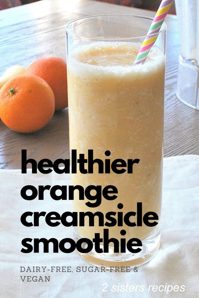 Healthier Orange Creamsicle Smoothis is served in a tall glass with a straw and 2 navel oranges on the side.