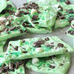 Pieces of St. Patrick's Day Green Chocolate Bark set on a table.