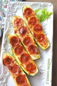 Zucchini Pepperoni Pizza Boats served on a white platter.
