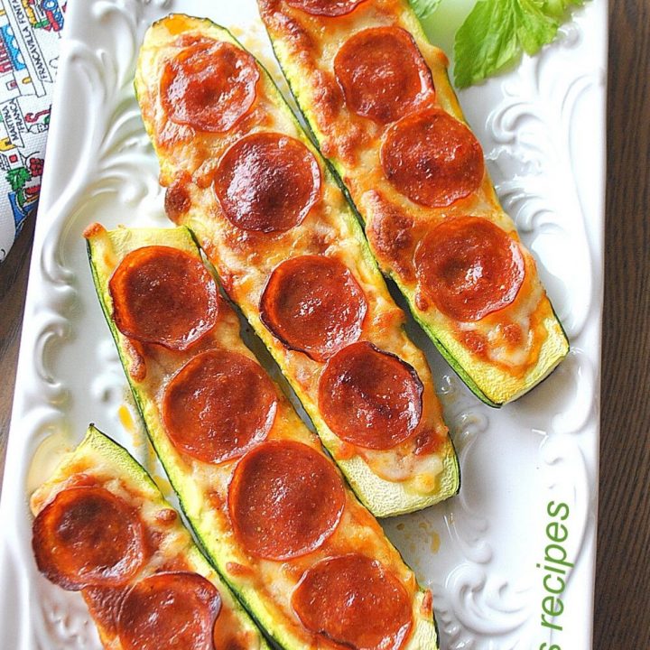 Zucchini Pepperoni Pizza Boats served on a white platter.