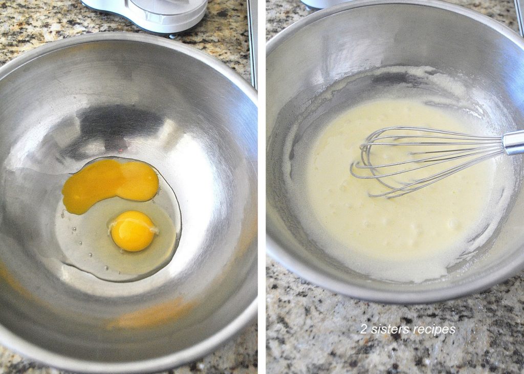 A silver bowl with 2 eggs, and a whisk whipping inside the bowl. 