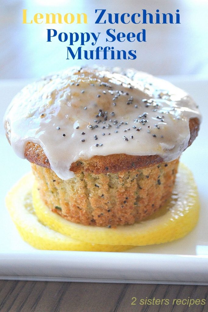 Lemon Zucchini Poppy Seed Muffin sitting on a slice of lemon on a white plate.