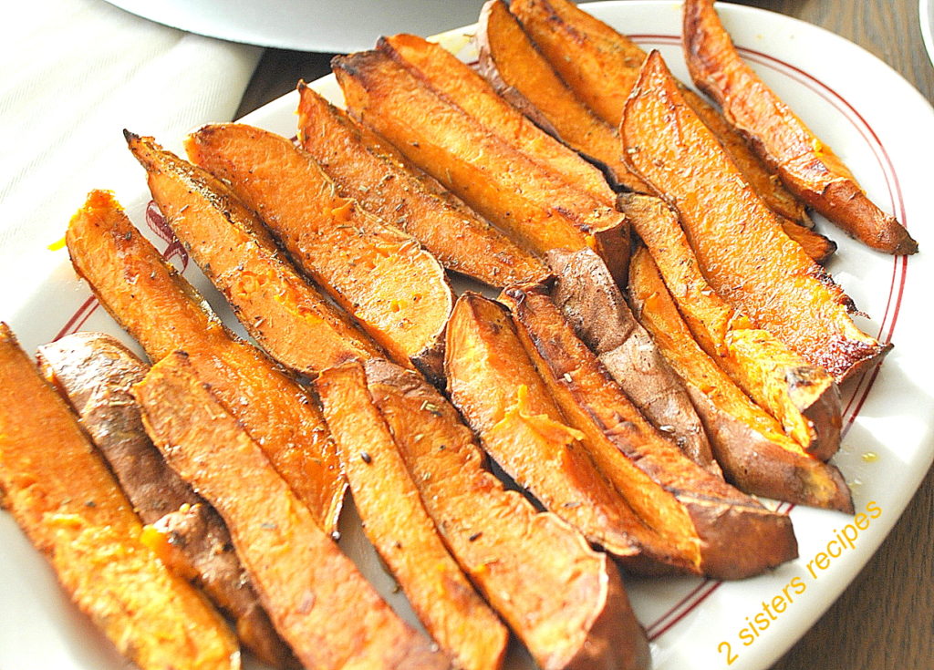A white platter filled with oven-fried sweet potatoes. 