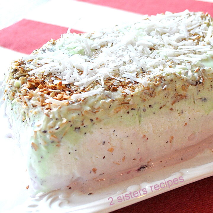 A rectangular shape ice cream with 3 different flavors served on a white platter.