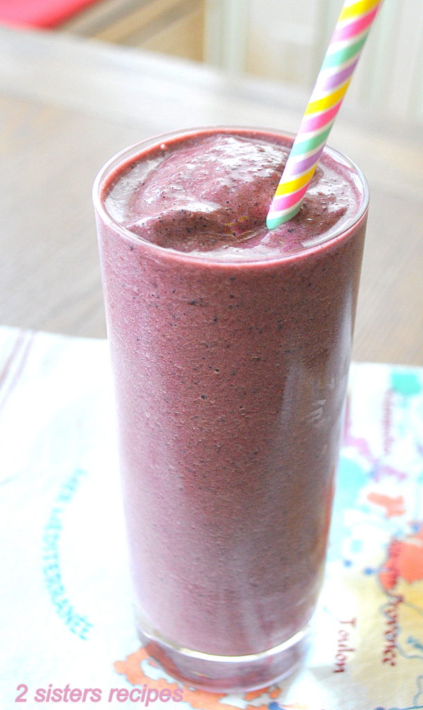 Beet Spinach Protein Smoothie is served in a tall glass with a colored stripe straw.