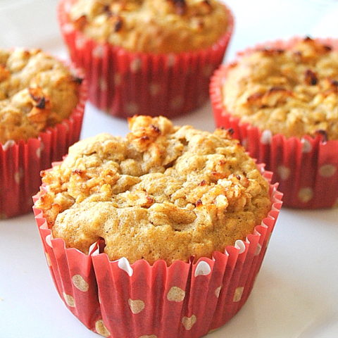 Four muffins served on a white plate.
