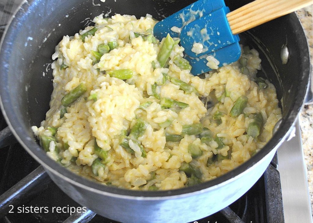 Asparagus Risotto cooking in a pot, by 2sistersrecipes.com