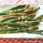 a bunch of asparagus served on a white platter,