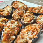 A white platter filled with mini stuffed eggplant in a platter