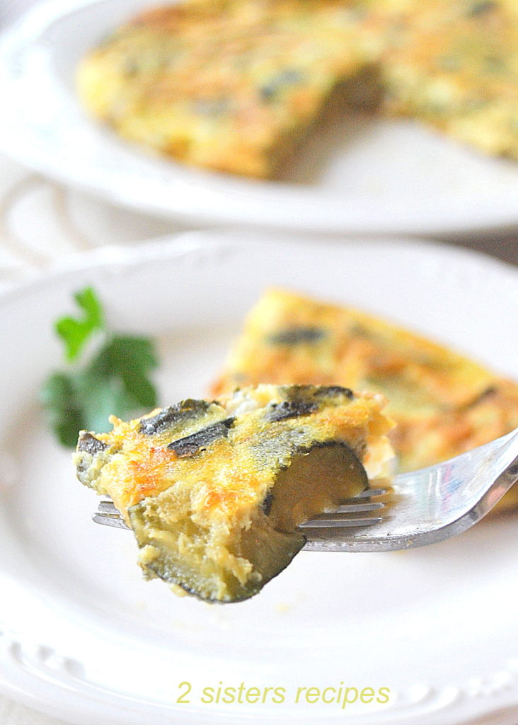 A forkful of an omelet made with zucchini. 