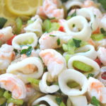Shrimp and Calamari Salad with lemon slices.