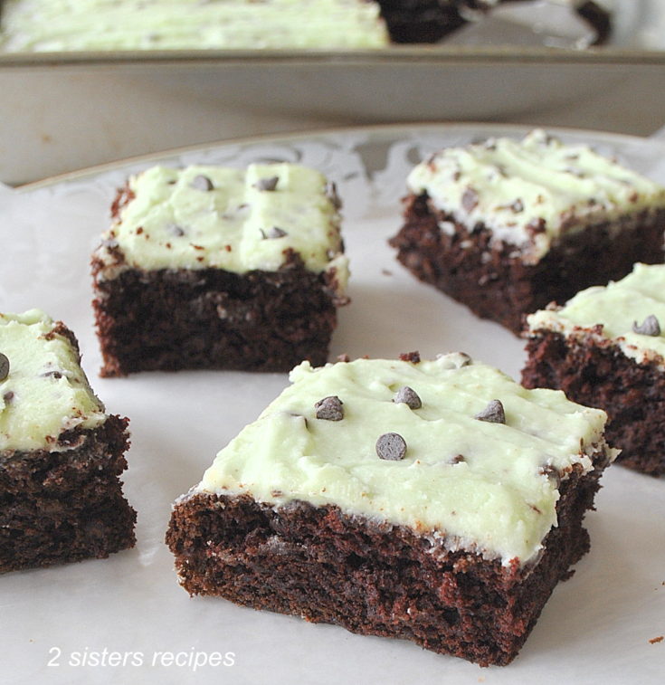 Cut up squares of Brownies on a white platter. by 2sistersrecipes.com