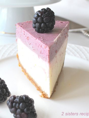 A slice of cheesecake on a white plate. by 2sistersrecipes.com