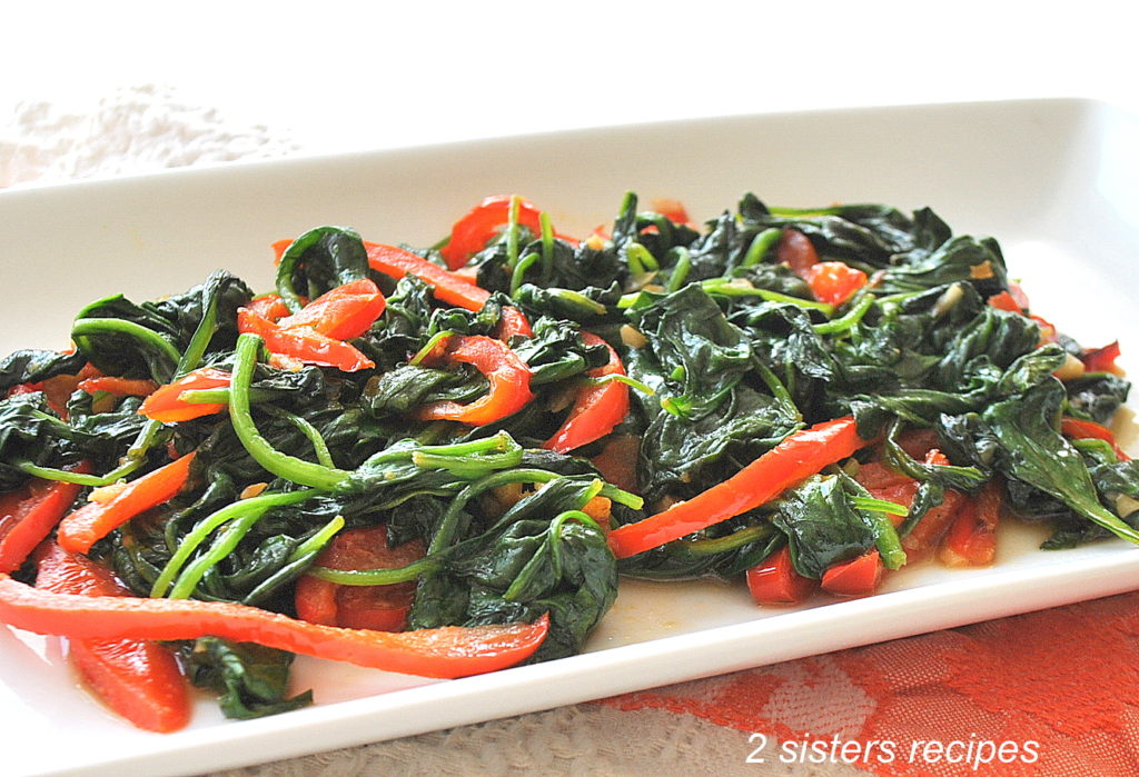 Sauteed Spinach with Garlic-Ginger & Peppers by  on a white platter.