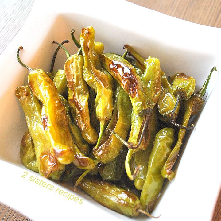 A white bowl as a barbecue side, our Baked Shishito Peppers.