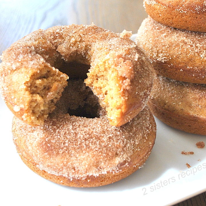 A bite out of a cinnamon apple cider donuts.