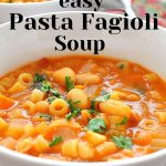 A white bowl of soup filled with with mini pasta and white beans.