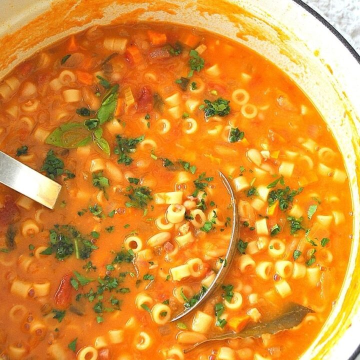 A big pot of bean soup with a ladle inside.