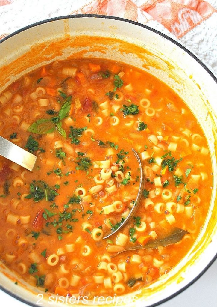 A big pot of bean soup with a ladle inside. 