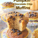 2 pumpkin muffins piled on the tables and one with a bite into it.