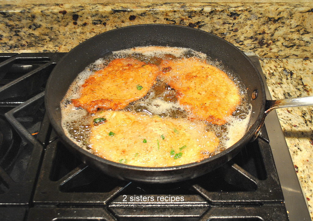 cutlets frying in a skillet on the stove. by 2sistersrecipes.com 