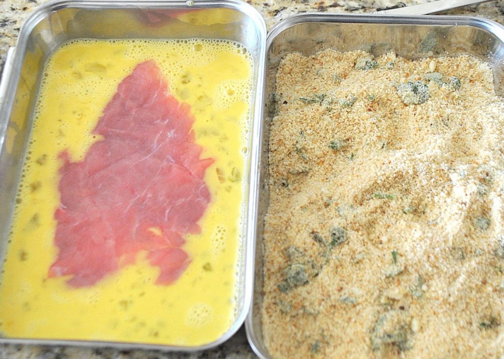 2 trays with veal in egg mixture and bread crumbs in the other. by 2sistersrecipes.com 