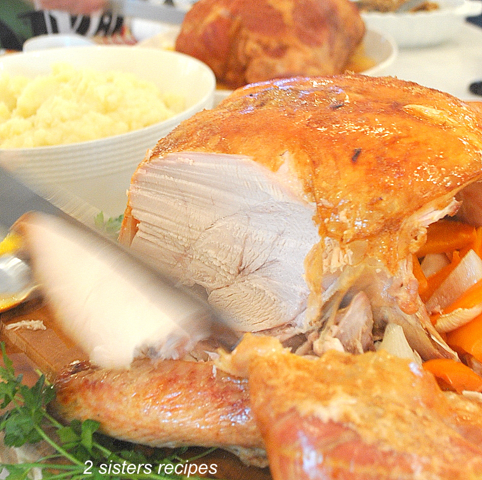 Carving a fully cooked roasted turkey by 2sistersrecipes.com