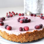 A cranberry cheesecake with sugar cranberries on top.