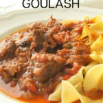 A serving of Hungarian Goulash featuring a meat sauce on noodles served on a white plate.