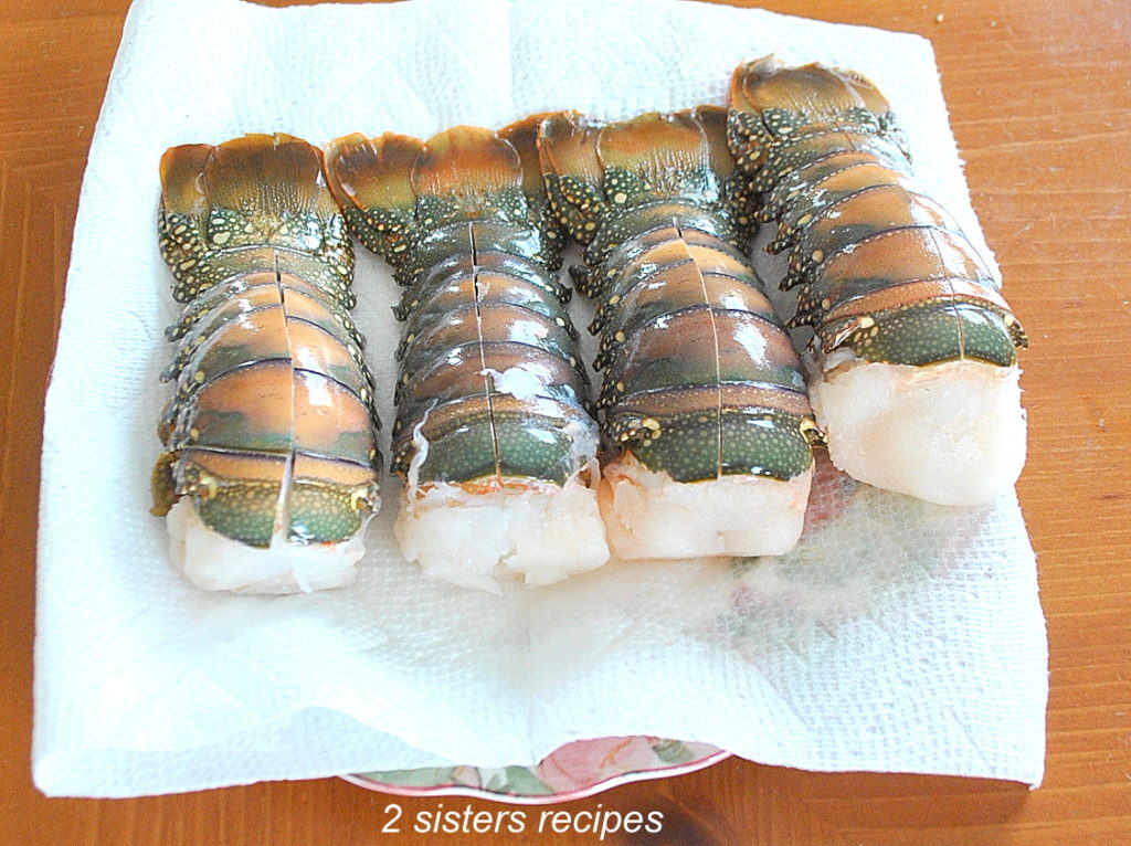 4 Lobster Tails draining on paper towels. by 2sistersrecipes.com