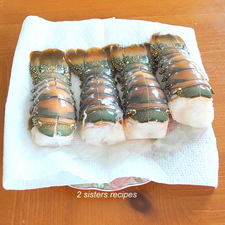 photo of 4 frozen lobster tails on paper towels. by 2sistersrecipes.com