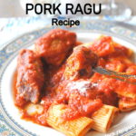 A forkful of sausage link smothered in a slow cooked tomato sauce served over rigatoni pasta.