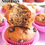 Two chocolate chip muffins with a bite out of one sitting on top of the other muffin.