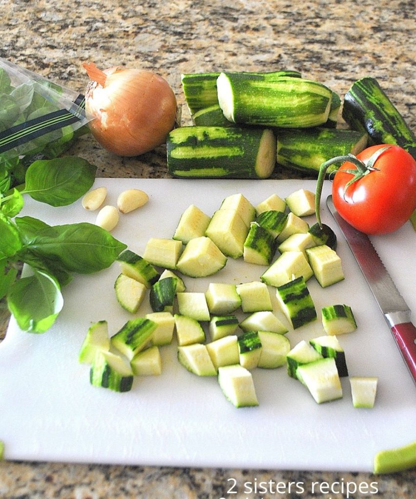 Ingredients on a white board for this zucchini stew. by 2sistersrecipes.com